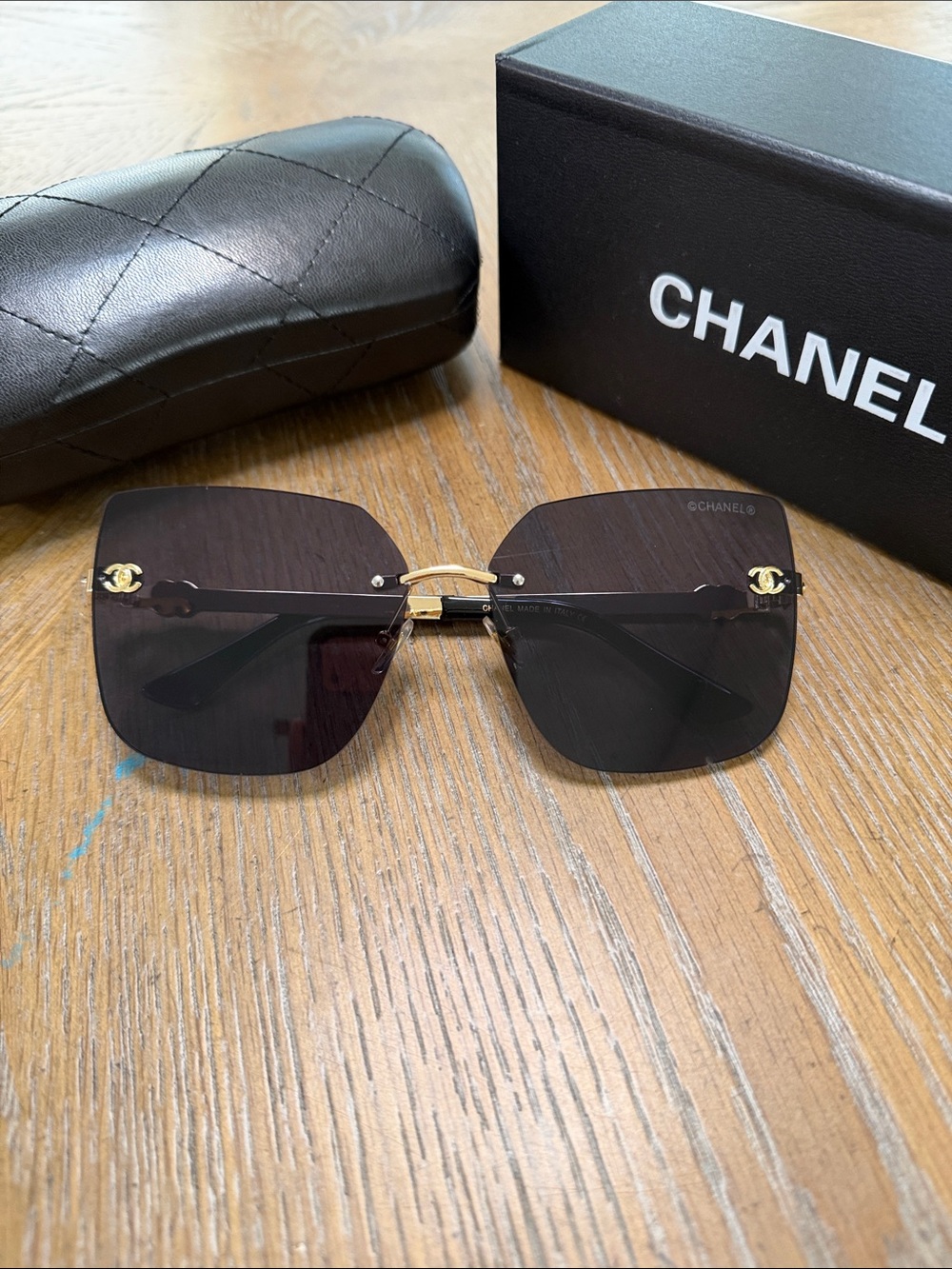 CHANEL Rimless Square Sunglasses in Black and Gold